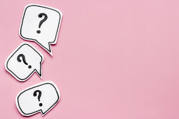Image shows question marks on a pink background