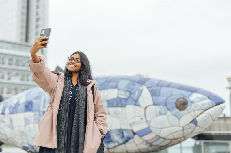 Student Florence takes selfie in front of the big fish
