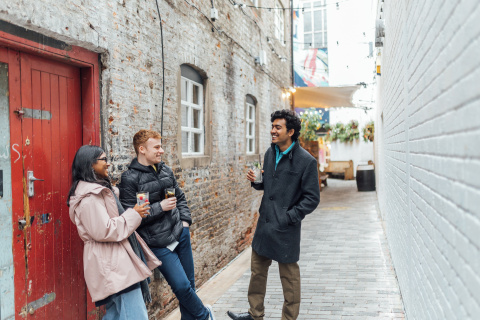 Three students standing in Joy's Entry