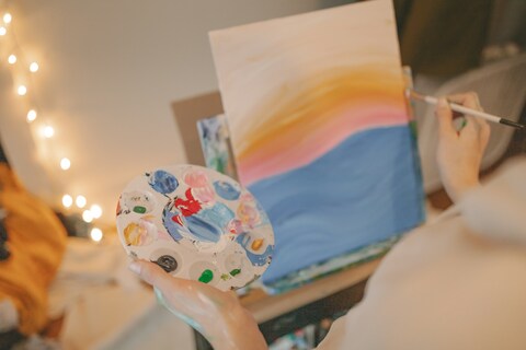 Person painting on canvas