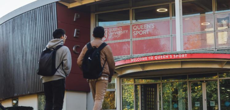 Two students walk towards PEC entrance