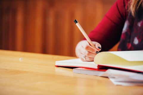 Student writing in notebook