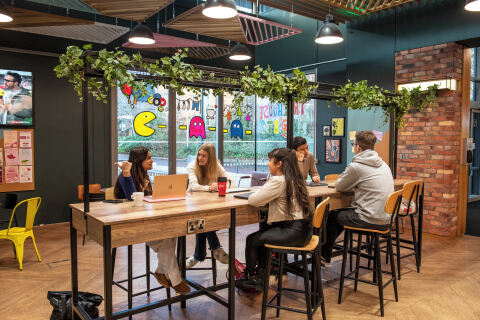 Two students talking at the coffee bar in the Treehouse, BT9
