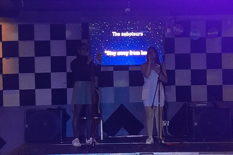 Two students singing at Taylor Swift karaoke event