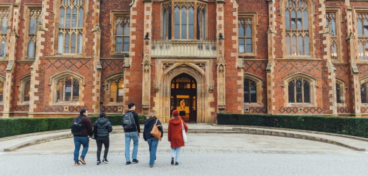 Group of students walk towards Lanyon