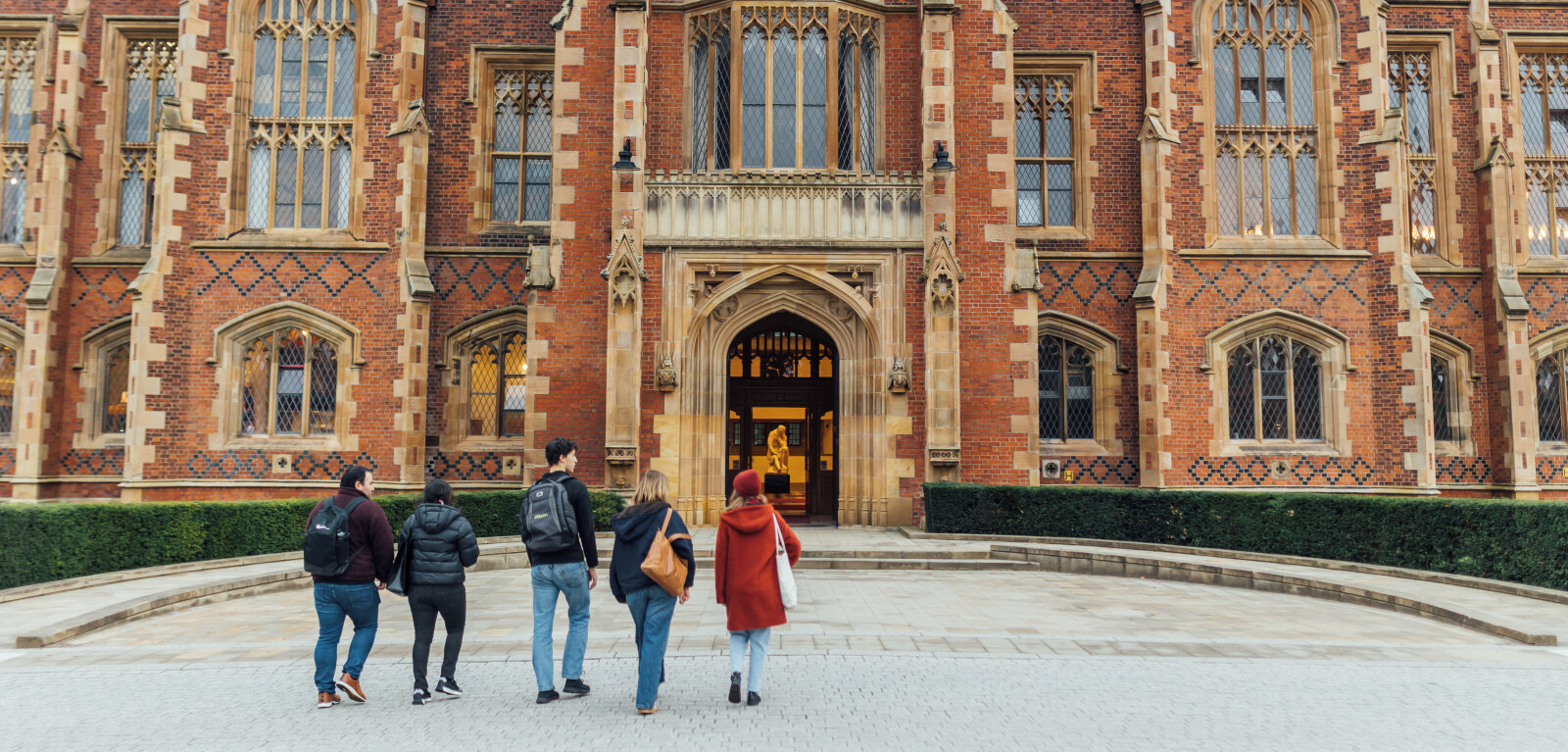 Group of students walk towards Lanyon