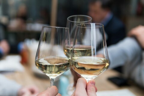 Three wine glasses in a 'cheers' position