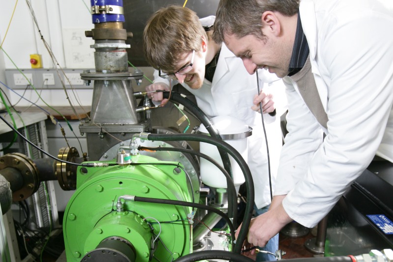 Researchers working with engine equipment
