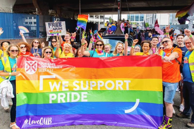 Queen's staff and students with banner at Belfast Pride Parade 2023